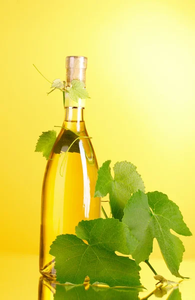 stock image White wine on yellow background