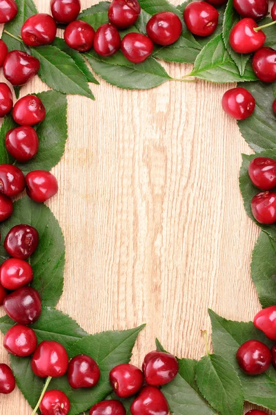 Cherries frame on wooden background — Stock Photo, Image