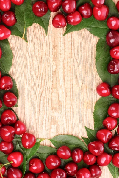 Cherries frame on wooden background — Stock Photo, Image