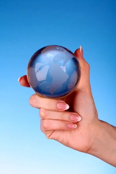 Crystal ball on hand. blue background — Stock Photo, Image