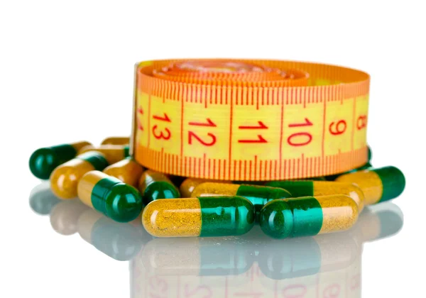 Diet pills and measuring tape — Stock Photo, Image