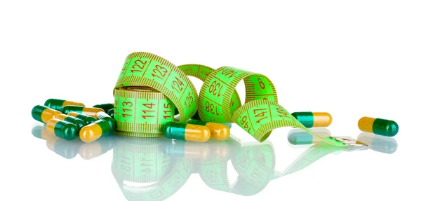 Pilulky na hubnutí a měřicí pásky — Stock fotografie