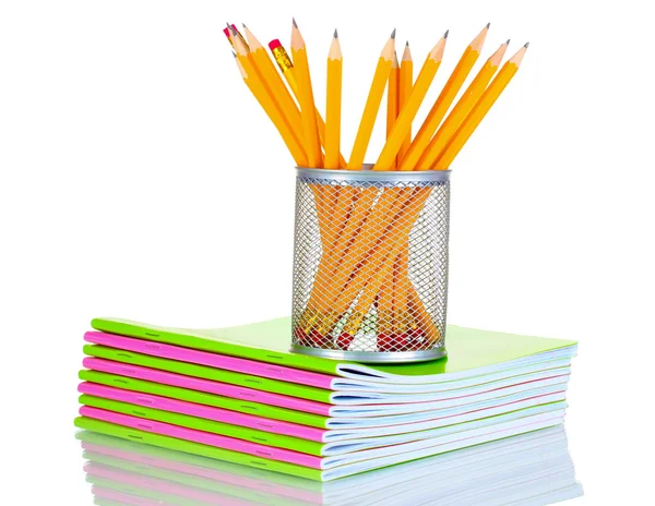 Pencils in holder and notebooks — Stock Photo, Image