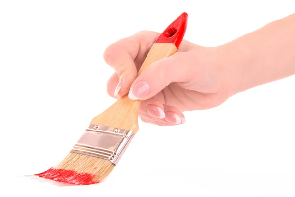 Fırça ve üzerinde beyaz izole kırmızı boya ile el — Stok fotoğraf