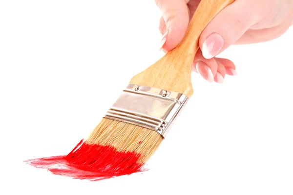 Hand with brush and red paint isolated on white — Stock Photo, Image