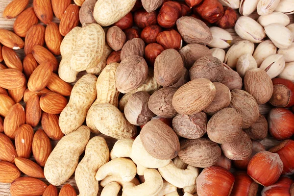 Nutmeg, peanuts and almonds — Stock Photo, Image