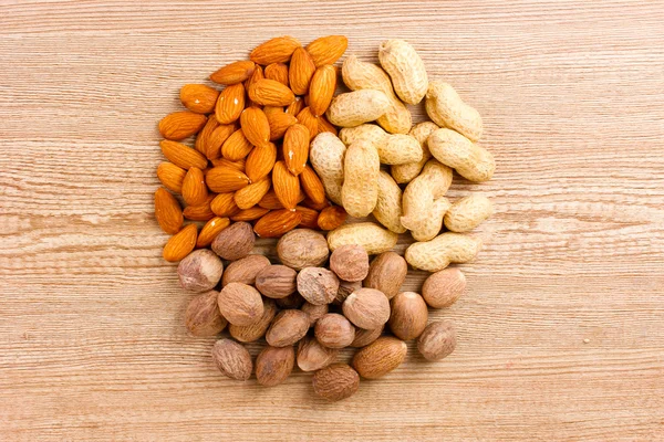 Nutmeg, peanuts and almonds — Stock Photo, Image