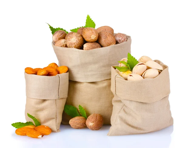 Nutmeg, pistachios and almonds in bags — Stock Photo, Image