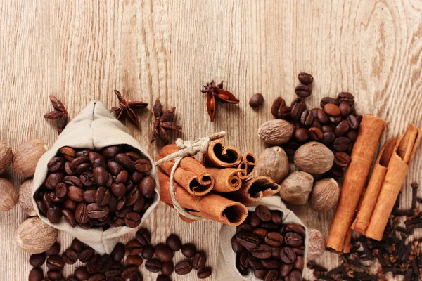 Kayu manis, kopi, pala dan hazelnut pada latar belakang kayu — Stok Foto