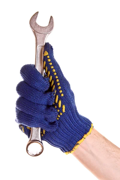 Schraubenschlüssel in der Hand mit Schutzhandschuh isoliert auf weiß — Stockfoto
