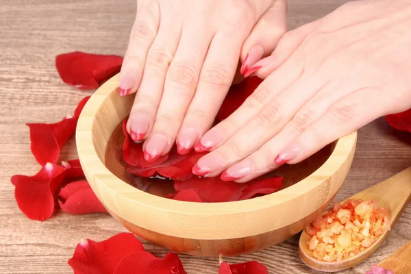 Hands in water with rose petals — Stock Photo, Image