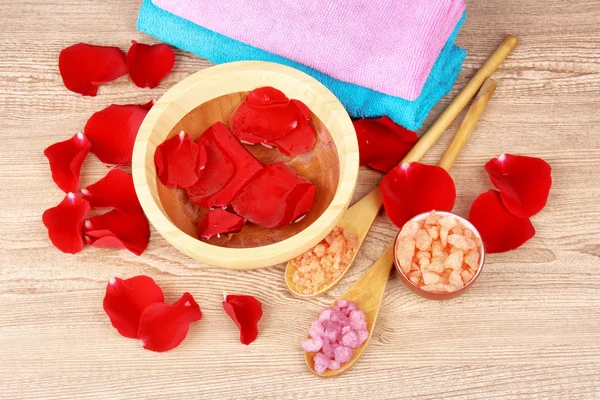 Rose petals, soap, bath salt and towel — Stock Photo, Image