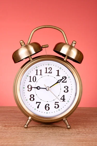 Old alarm-clock on red background — Stock Photo, Image
