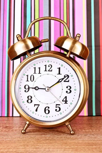 Alarm-clock on color lines background — Stock Photo, Image