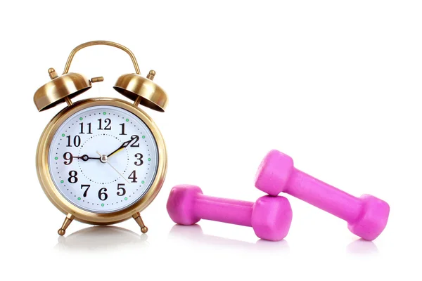 Old alarm-clock and dumbbells isolated on white — Stock Photo, Image