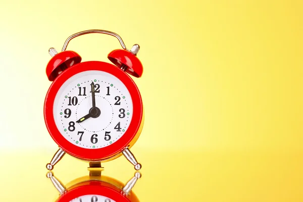 Alarm-clock on yellow background — Stock Photo, Image