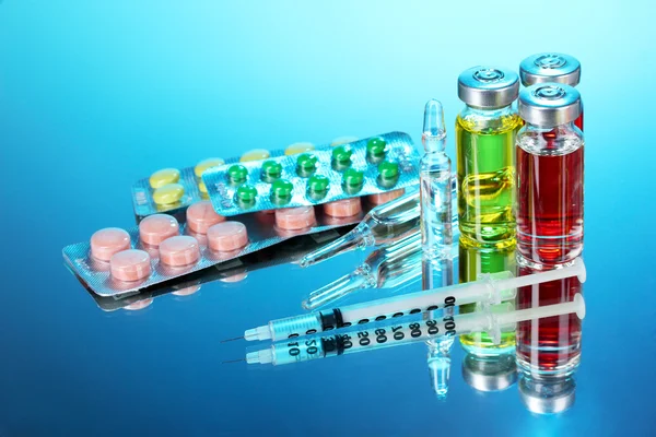 Medical ampoules, pills and a syringe — Stock Photo, Image
