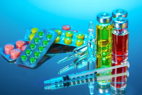 Medical ampoules, pills and a syringe — Stock Photo, Image