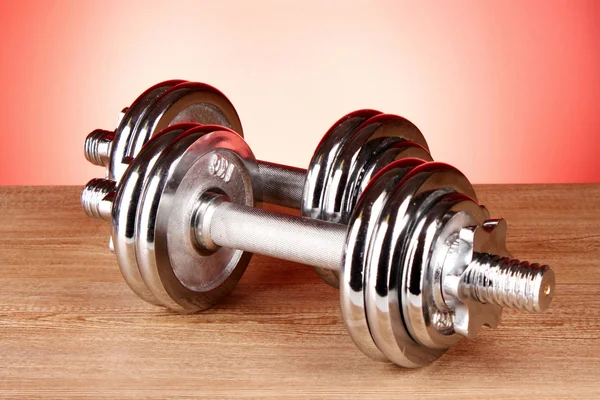 Dumbbell on red background — Stock Photo, Image