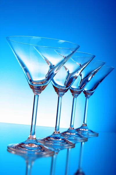 Empty glasses of martini on the light blue background — Stock Photo, Image