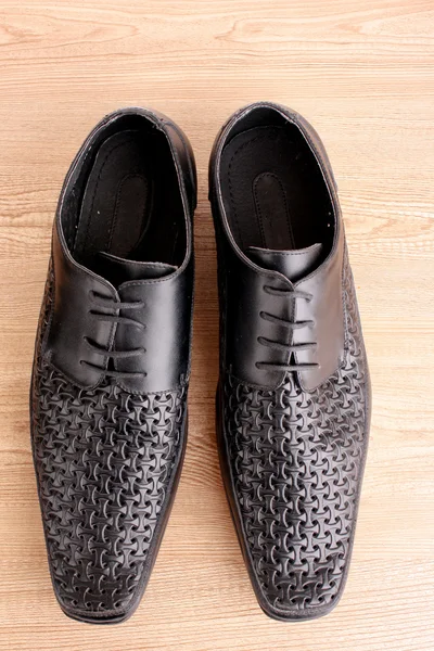 Pánské boty na dřevěné textury — Stock fotografie