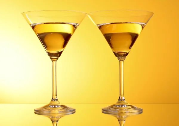 Two glasses of martini on a yellow background — Stock Photo, Image