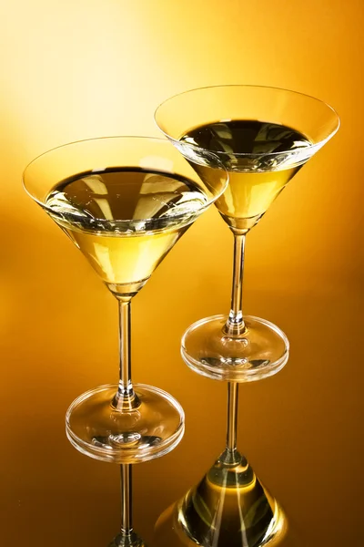 Two martini glasses on yellow background — Stock Photo, Image