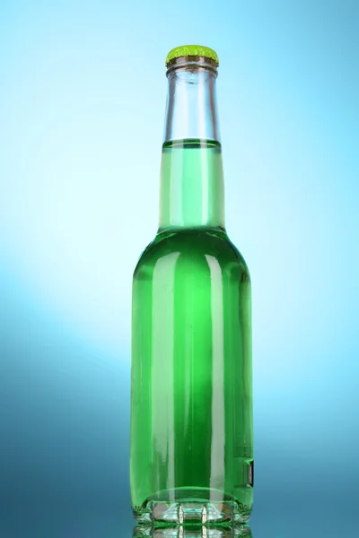 Flasche mit Alkohol auf blauem Hintergrund — Stockfoto