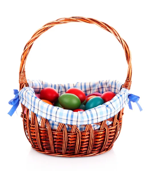 Wicker basket with Easter eggs isolated on white — Stock Photo, Image
