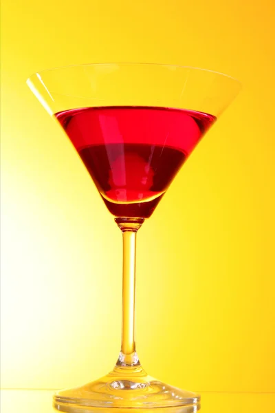 Vidrio con una bebida alcohólica verde a un fondo amarillo-marrón — Foto de Stock