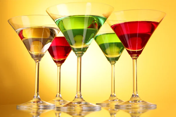 Unos vasos de bebidas alcohólicas en un fondo amarillo-marrón — Foto de Stock