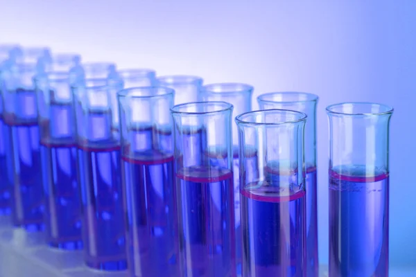 Test-tubes on blue background — Stock Photo, Image