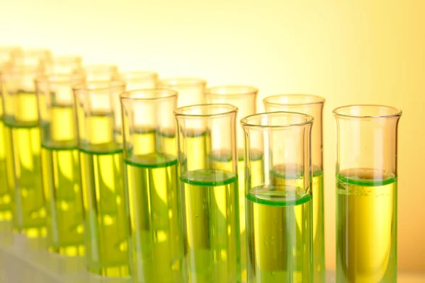 Test-tubes on yellow background — Stock Photo, Image