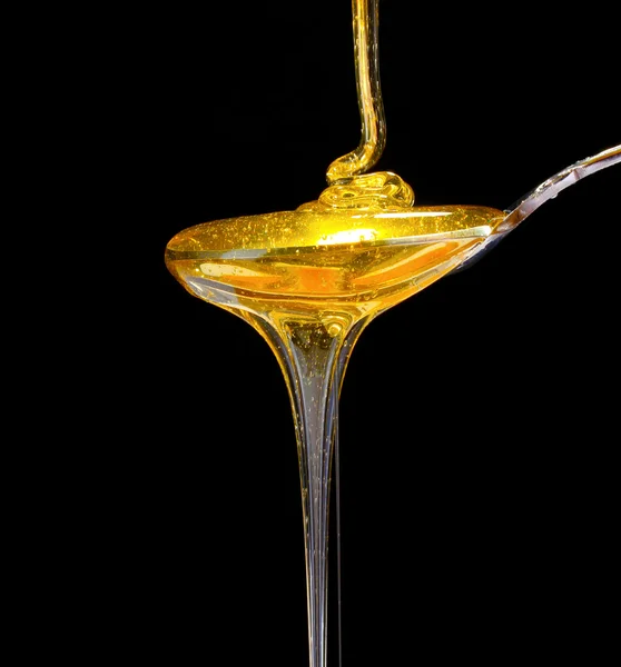 Smaker honning i skje – stockfoto