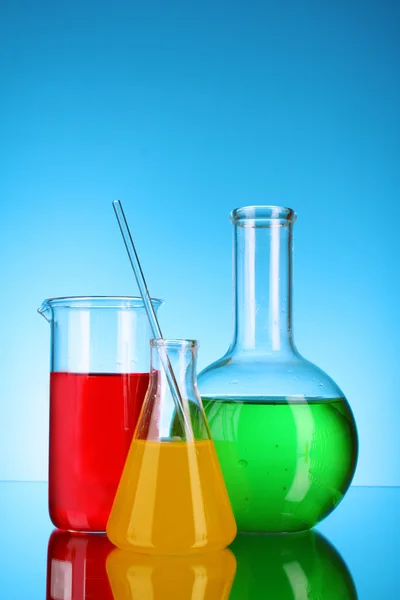 Laboratory glassware on blue background — Stock Photo, Image