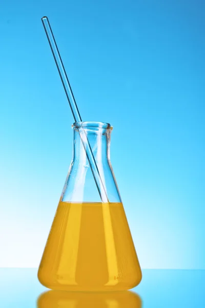 Conical flask on blue background — Stock Photo, Image