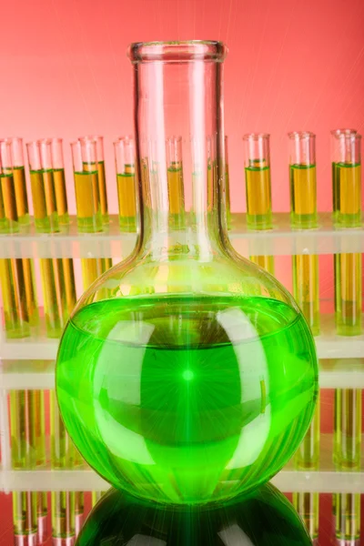 Flask on test-tubes background — Stock Photo, Image