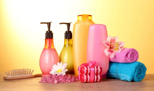 A set of bath cosmetics on yellow background — Stock Photo, Image