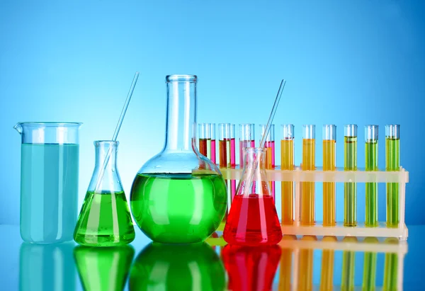 Laboratory glassware on blue background — Stock Photo, Image