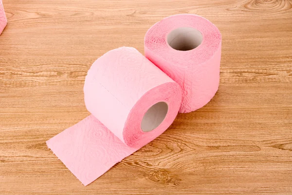 Toilet paper on wooden table — Stock Photo, Image