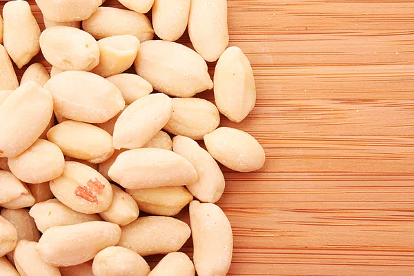 stock image Peanuts on wooden background