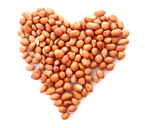 Peanuts in heart symbol isolated on white — Stock Photo, Image