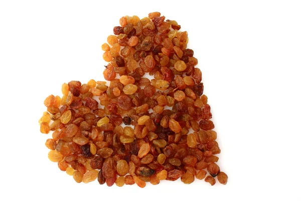 Yellow raisins in love symbol isolated on white — Stock Photo, Image