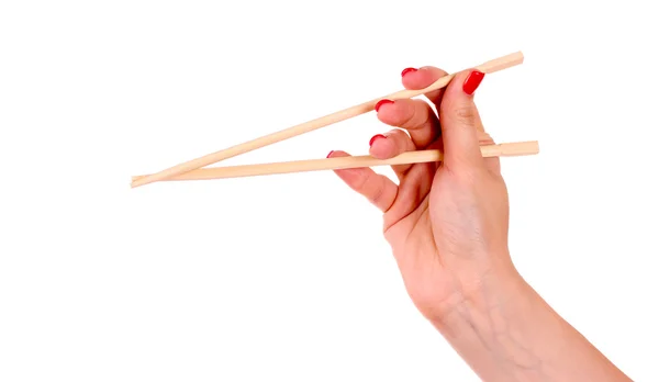 Woman's hand and wooden chopsticks — Stock Photo, Image