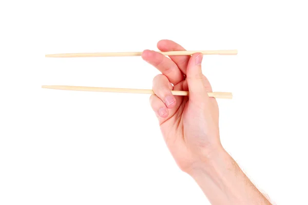 Женская рука и деревянные палочки для еды — стоковое фото