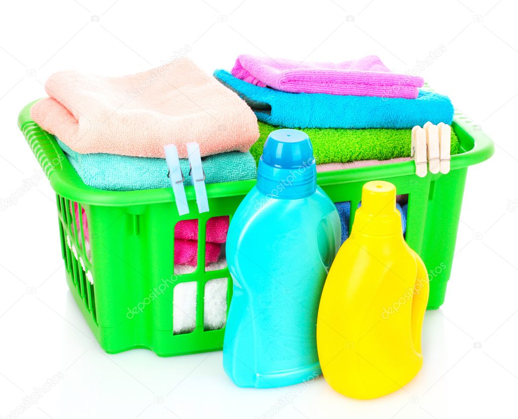 Detergents and towels in basket isolated on white