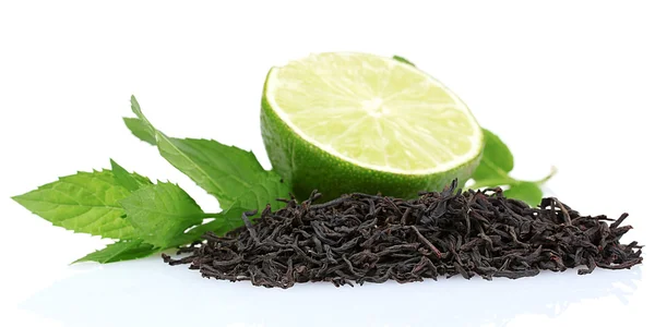 stock image Dry black tea leaves, lime and mint