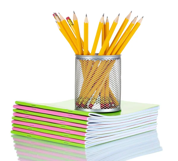 Pencils in holder and notebooks — Stock Photo, Image