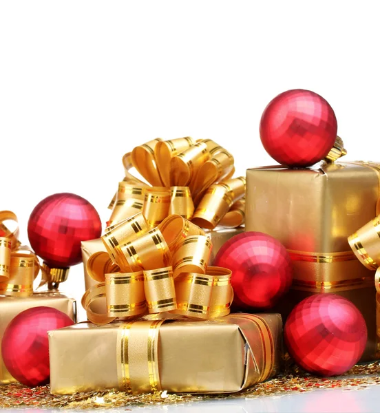 Beautiful gifts in gold packaging and Christmas balls isolated o — Stock Photo, Image
