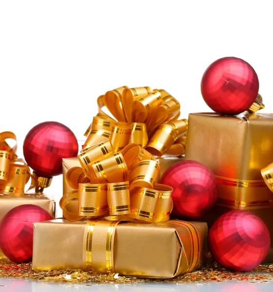 Beautiful gifts in gold packaging and Christmas balls isolated o — Stock Photo, Image